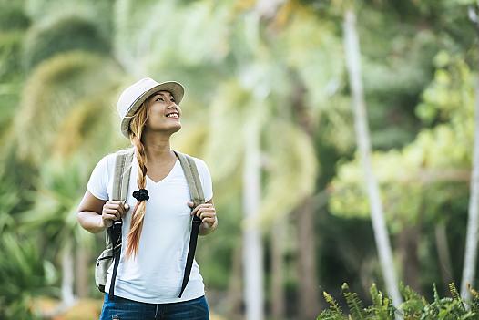 young-tourist-woman-with-backpack-enjoy-nature-looking-away